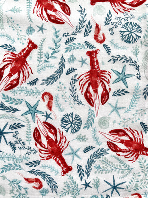 Close up of Lobsterpalooza adult bib made of premium cotton with swimming lobster fun