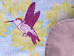Hummingbirds in Spring is one of our favorite BAVETTE adult bib designs for women. Cheerful hummingbirds buzz to make an elegant statement in a stylish, washable, 100% premium cotton dining bib and clothing protector for seniors and adults with special needs.
