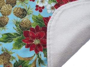 Magic Poinsettias adult bib features colorful flowers on one side and soft cotton flannel on the backside.