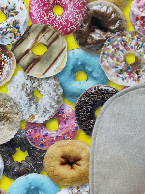 Close up view of donut-covered cotton adult bib with soft flannel back side. 