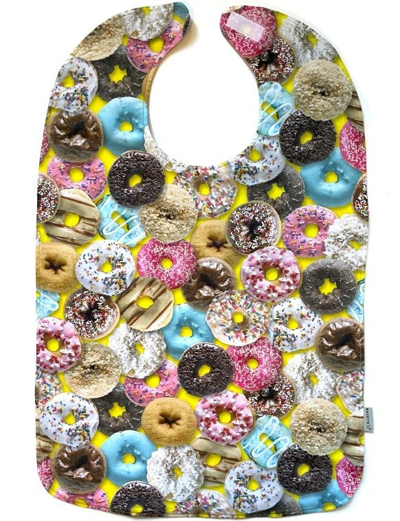Colorful donuts star in this fashionable and machine washable cotton adult bib by BAVETTE