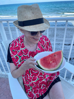 Woman wearing premium cotton adult bib by BAVETTE Bibs featuring colorful watermelon design.